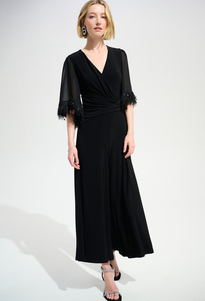 woman wearing a black jumpsuit on a white background