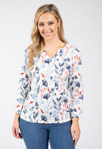 Woman wearing a floral blouse with long sleeves on a white background