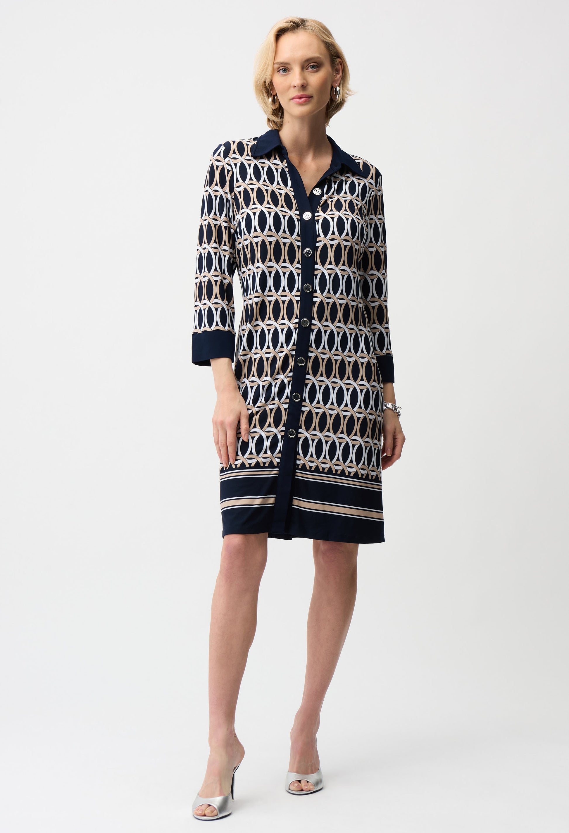 Woman wearing a patterned dress on a white background