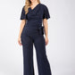 Woman wearing a navy blue jumpsuit on a white background