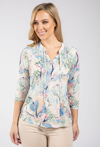 Woman wearing a floral blouse with a white background