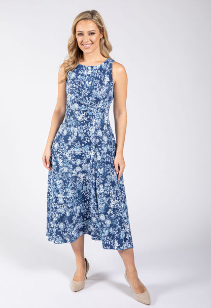 Woman wearing a blue floral dress on a white background