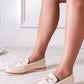 White loafers worn by a person on a light background