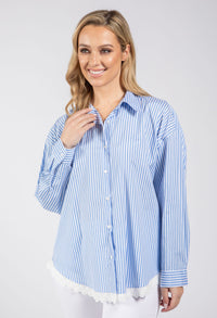 Woman wearing a blue and white striped shirt on a plain background