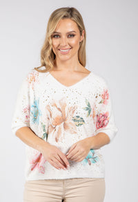 woman wearing a soft knit pullover with floral design