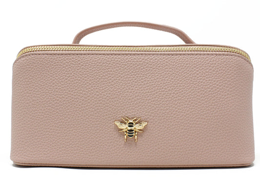 Pink cosmetic case with a gold bee emblem on a white background