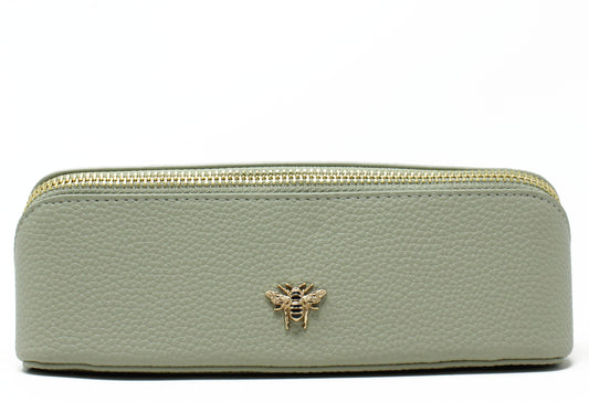 Light green make up bag with a gold zipper and bee emblem on a white background