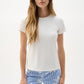 Woman wearing a white top and blue floral pants on a white background