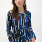 Woman wearing a blue and black patterned blouse on a white background