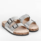 Silver glitter sandals with cork sole on a white background