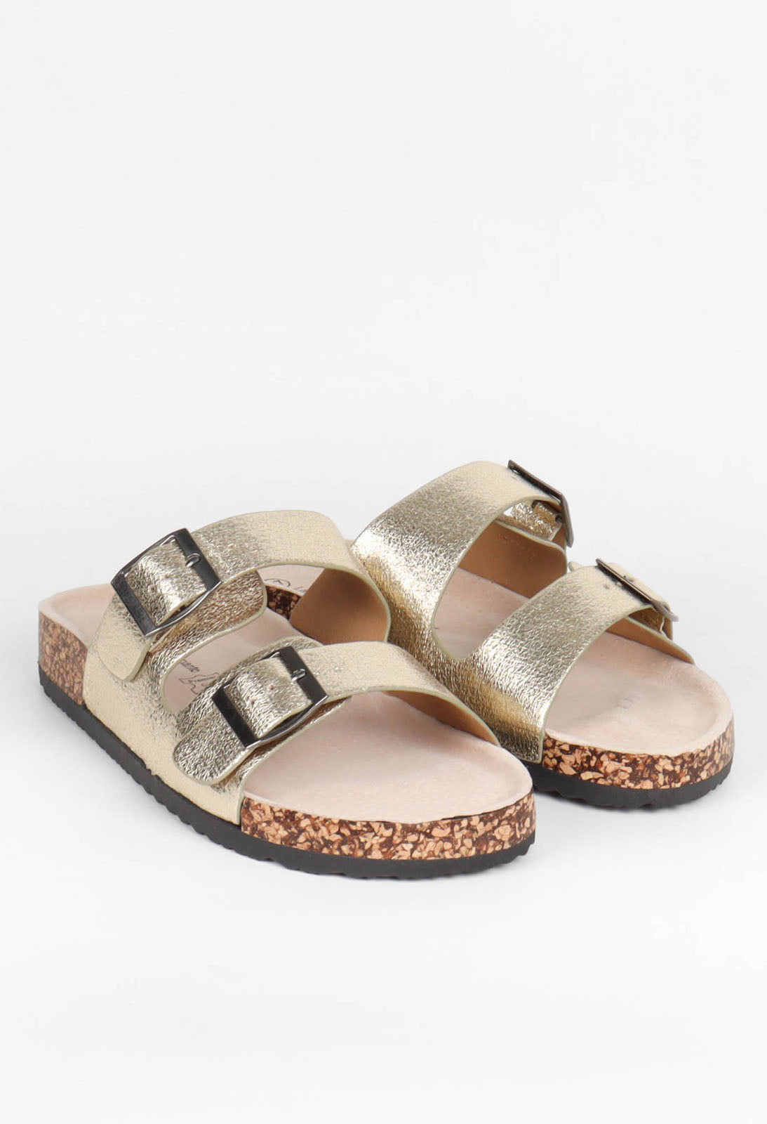 Pair of gold sandals with cork soles on a white background