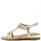 Gold sandal with a strap design on a white background