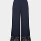 Navy blue pants with black sequin trim on a white background