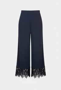 Navy blue pants with black sequin trim on a white background