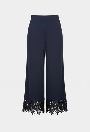 Navy blue pants with black sequin trim on a white background