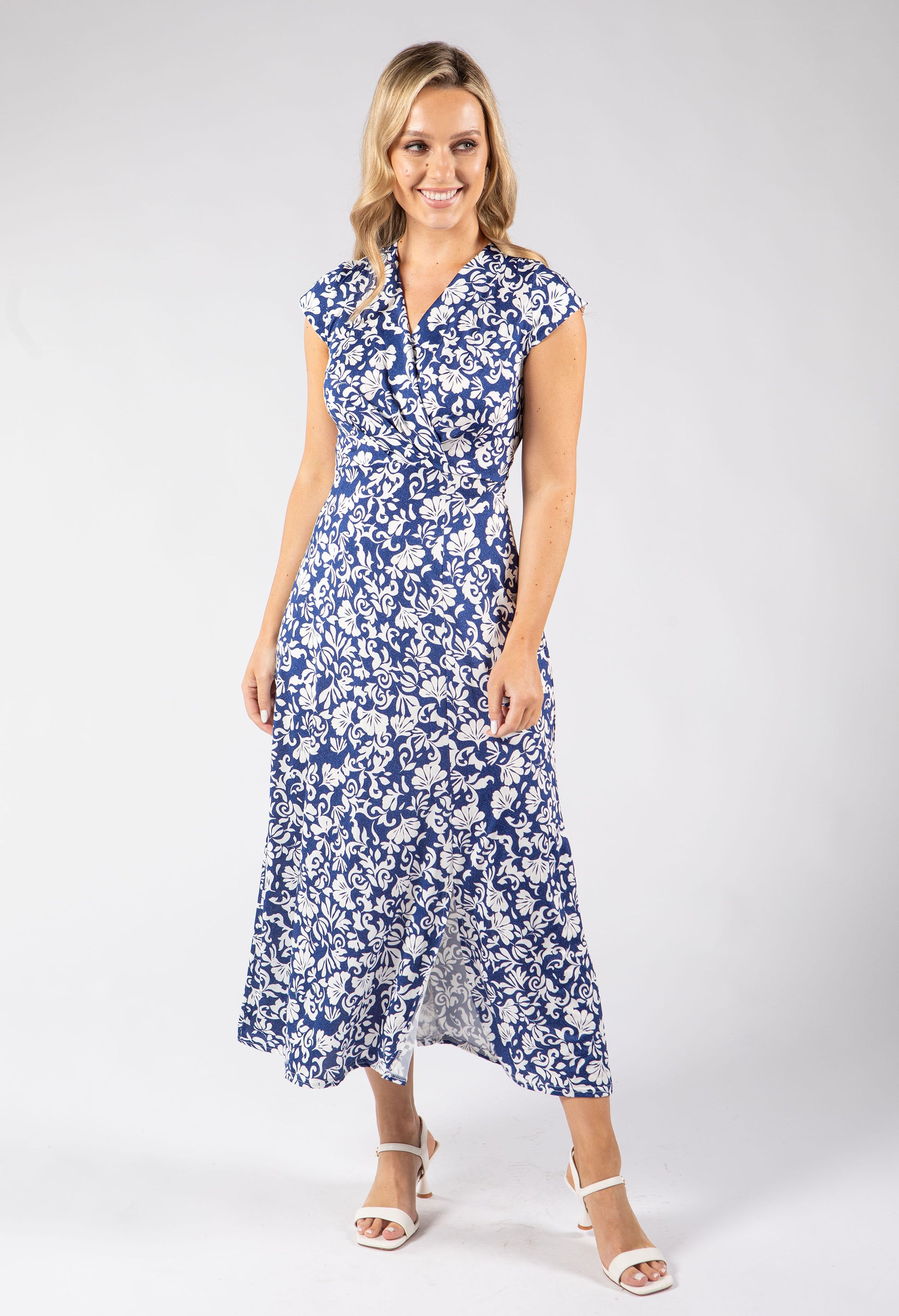 Woman wearing a blue floral dress on a white background
