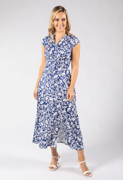 Woman wearing a blue floral dress on a white background