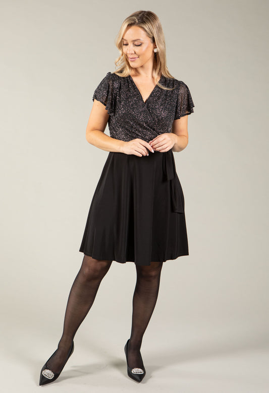 Woman wearing the metallic angel sleeve wrap dress with flowing sleeves and wrap front
